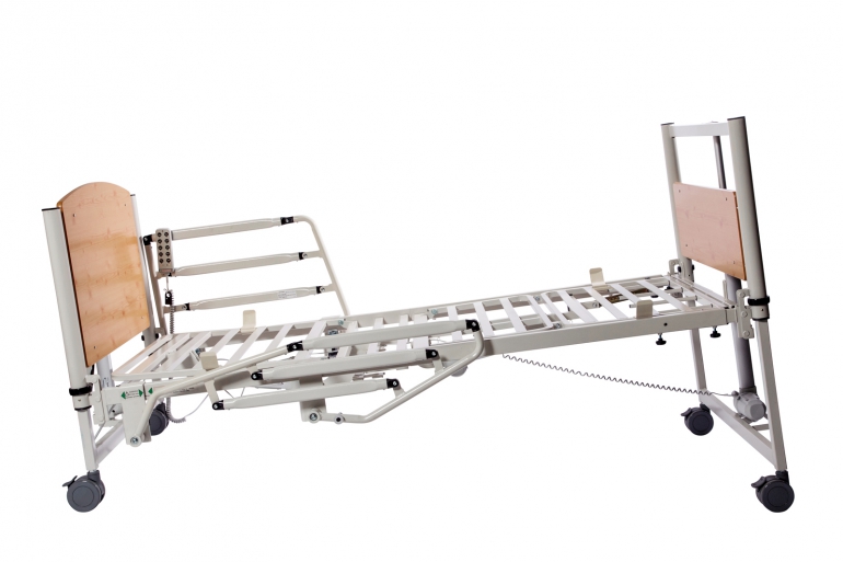The 8199 Home Care Bed is shown from the side with half rails, in Trendelenburg (feet up) position.