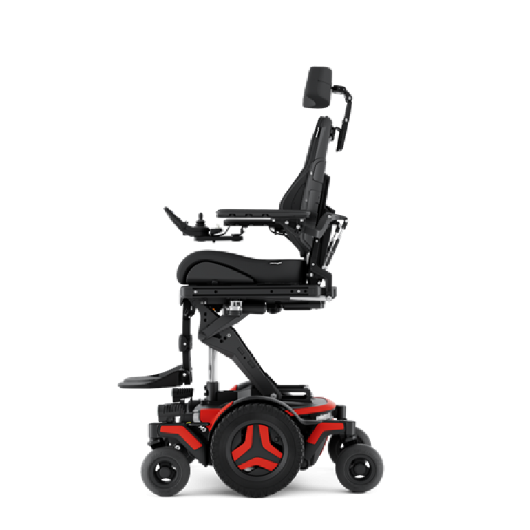 The Permobil M3 Corpus power chair with red accents is shown from the side, elevated by 12 inches with the optional ActiveHeight feature