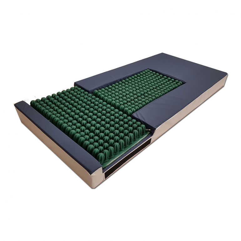 The t-style mattress is shown with air-filled inserts for pressure redistribution at the coccyx and heels.