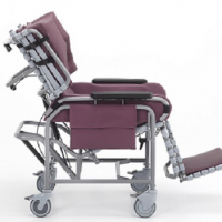 The Broda centric positioning wheelchair with burgundy padding, shown from the side.
