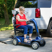 A woman drives her mobility scooter off of the Out-Sider scooter lift that is installed on the back of her vehicle. thumbnail