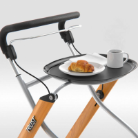 The Let's Go Indoor Rollator is shown in the Beech colour, with the removable tray. Someone is feeling peckish because the tray has a croissant and a mug of coffee on it. thumbnail