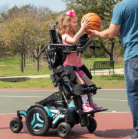 A girl uses the M Corpus VS Standing Wheelchair thumbnail